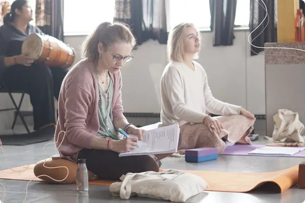 yoga teacher trainees studying philosophy and teaching methodology during 500 hour training in Rishikesh