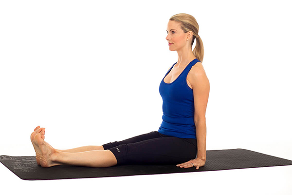 woman performing dandasana