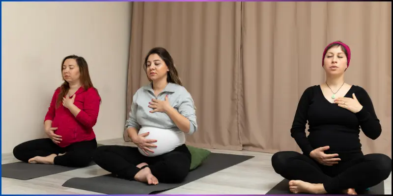 pregnant women doing hot yoga