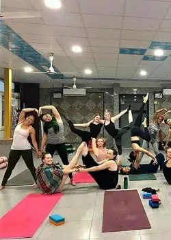 Students practising partner acro yoga together in the studio