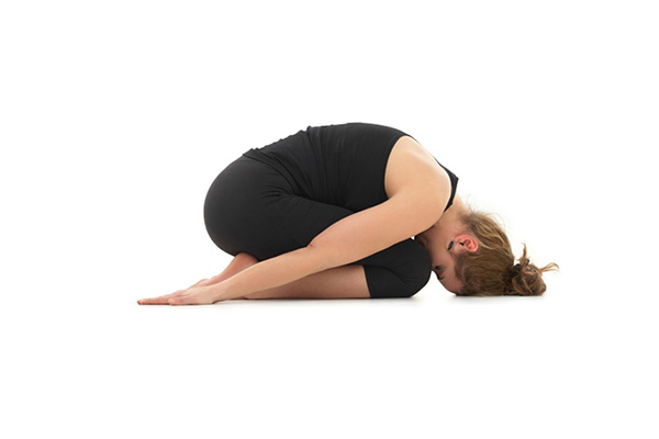 woman performing balasana