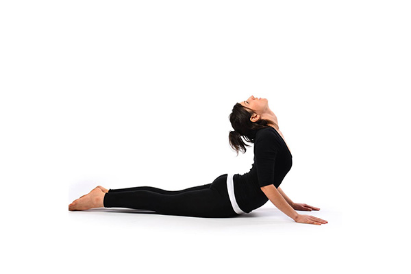 a woman performing bhujangasana